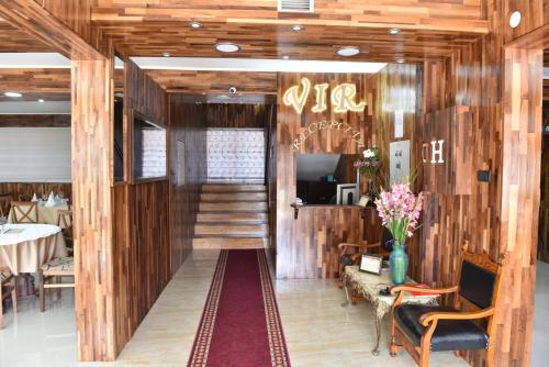 a hallway with wood paneling and a staircase in a restaurant at Hotel "VIR" in Velika Plana
