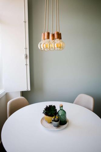 a white table with a potted plant on it at Casas do Jardim in Marco de Canavezes