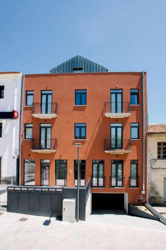 a building with a red traffic light in front of it at Casas do Jardim in Marco de Canavezes