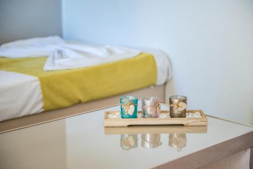 a room with a bed and a table with candles at Kavos Hotel & Suites in Stavros