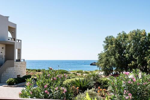 a house with a view of the ocean at Kavos Hotel & Suites in Stavros