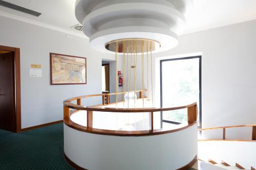 a circular staircase in a room with a large window at Cervara Park Hotel in Rome