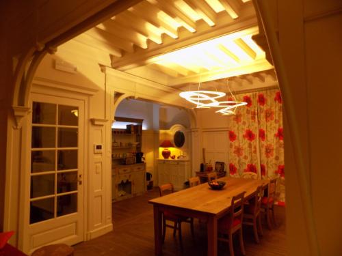a dining room with a wooden table and chairs at B&B Les Tilleuls in Vielsalm