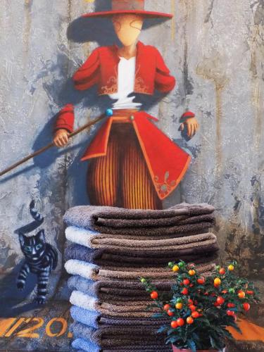 a painting of a man with a broom and a pile of blankets at B&B Les Tilleuls in Vielsalm