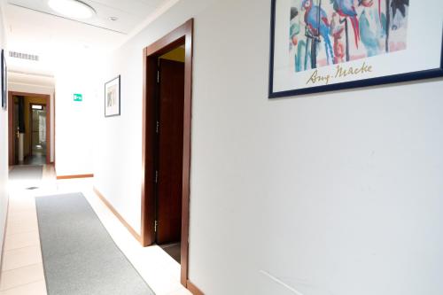 a hallway with a door and a picture on the wall at Cervara Park Hotel in Rome