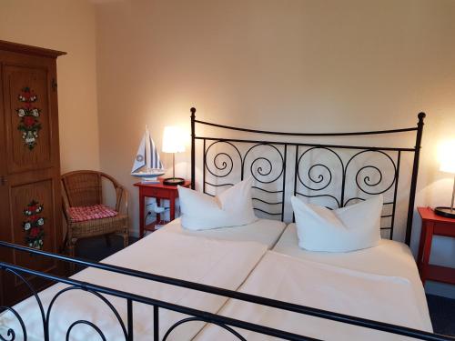 a bedroom with a large bed with white sheets and pillows at Hotel Schleimünde in Kappeln