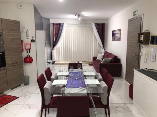 a living room with a table and a couch at Marsascala Sea View Apartment & Penthouse in Marsaskala