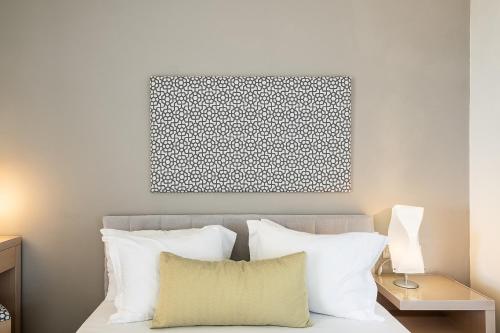 a bedroom with a bed with white pillows at Kavos Hotel & Suites in Stavros