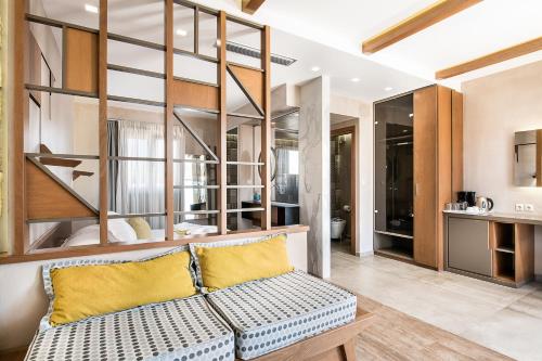 a living room with a couch and a kitchen at Kavos Hotel & Suites in Stavros