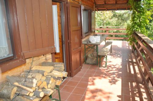 a porch of a house with a table and a bench at Etna Baite Milo in Milo