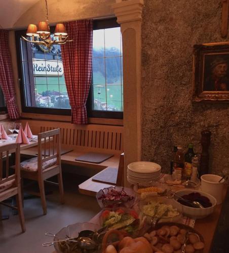 a kitchen with a table with food on it at Bergchalet Hotel Reinerhof in Riva di Tures