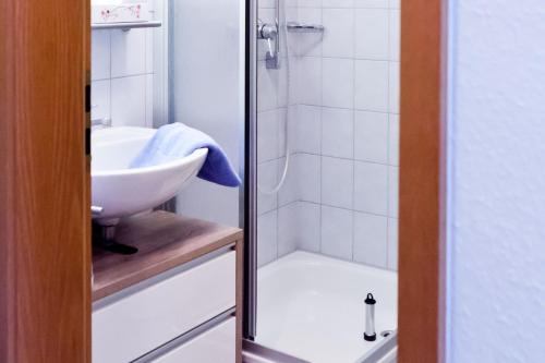 a bathroom with a sink and a shower at Haus Keller Ferienwohnungen in Todtnauberg