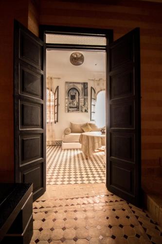 an open door leading to a living room with a couch at Riad Abjaou in Marrakech
