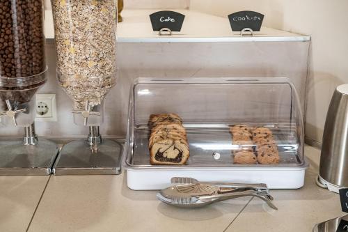 a kitchen counter with a tray of cookies on it at Kavos Hotel & Suites in Stavros