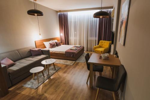 a living room with a couch and a table at Central Plaza Apartments in Niš
