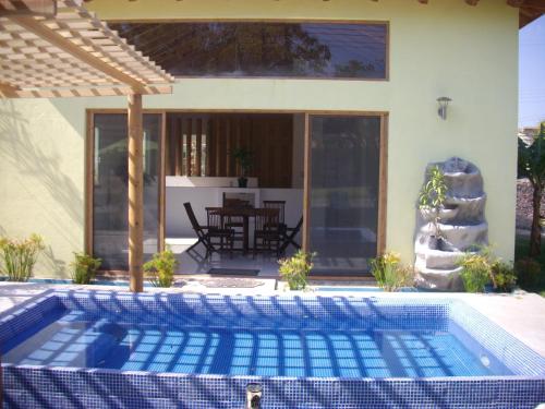 a swimming pool in front of a house at Villas Premier in Tequisquiapan