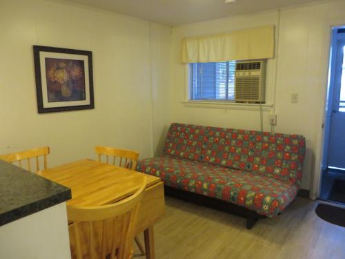 a living room with a couch and a table at Elmwood Motor Court in Old Orchard Beach