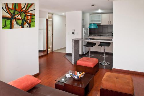 a living room with a couch and a table at Aparta-Suites Mirador del Recuerdo in Bogotá