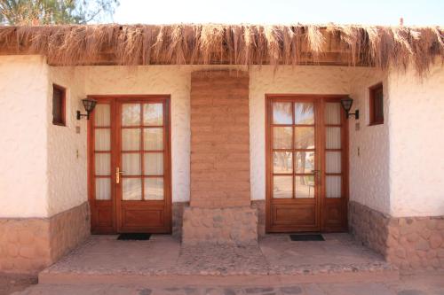 an old brick building with a door open at Hotel Diego de Almagro San Pedro De Atacama in San Pedro de Atacama