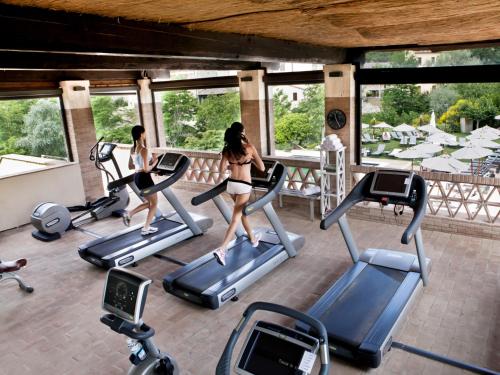 a group of women running on treadmills in a gym at Castel Monastero - The Leading Hotels of the World in Castelnuovo Berardenga