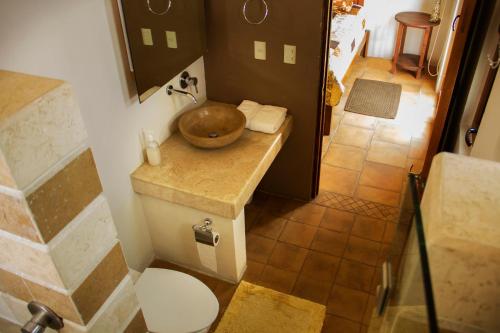 a bathroom with a bowl on top of a toilet at Casa Toscana - Coronado 18 in San Miguel de Allende