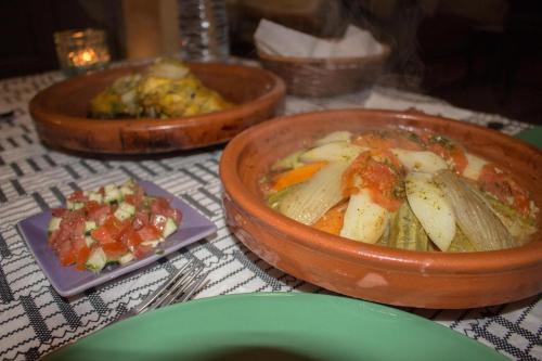 a table with three bowls of food on a table at Riad Abjaou in Marrakech
