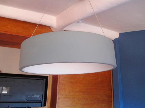 a white light fixture hanging from a ceiling at Quinua Boutique Apartments in Cusco