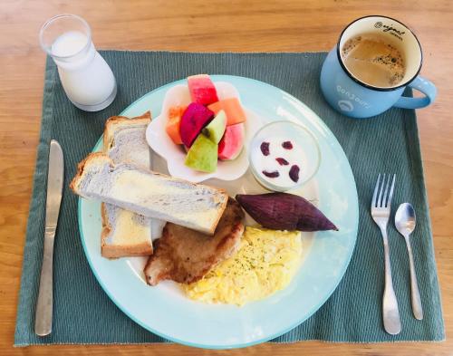 a plate of breakfast food with eggs bread and fruit at Lanshan House in Donghe