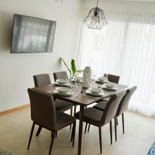 a dining room table with chairs and a dining room at Metropolitan Suites in Guadalajara