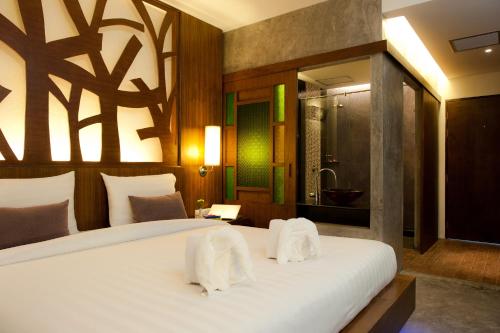 Postel nebo postele na pokoji v ubytování De Cozé Hotel