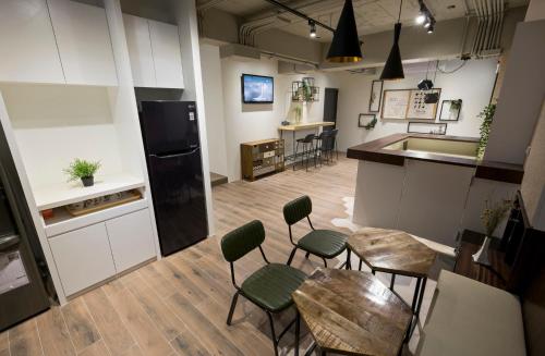 a kitchen with chairs and a table and a counter at 109台北旅館-台北109青旅 109 Taipei Hotel - Taipei 109 Hostel in Taipei
