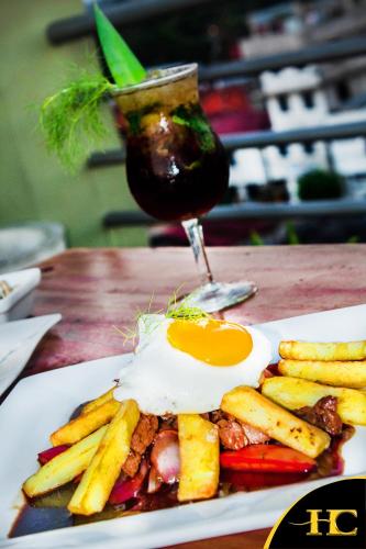 a plate of food with an egg and french fries at Hotel Centenario in Puerto Maldonado