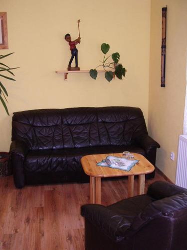 a living room with a couch and a table at Penzion Olga in Mariánské Lázně