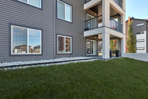 a house with a green lawn in front of it at 5 STAR Business Luxury Homeshare in Edmonton