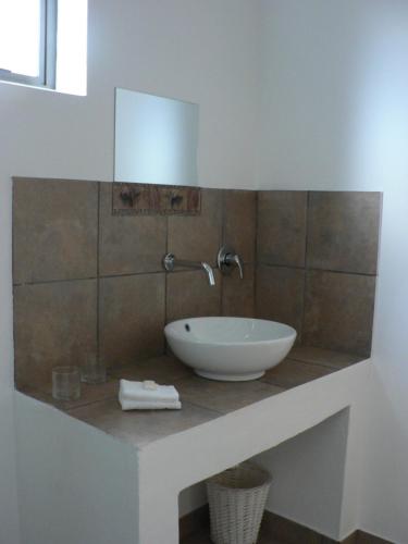a bathroom with a sink and a mirror on a counter at Mountain View Eco Lodge Montagu in Montagu