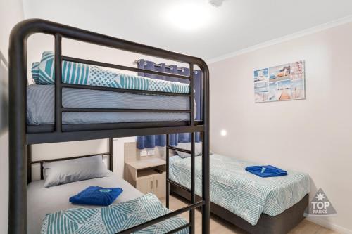 a bunk bed room with two bunk beds in it at Horrocks Beach Caravan Park in Horrocks