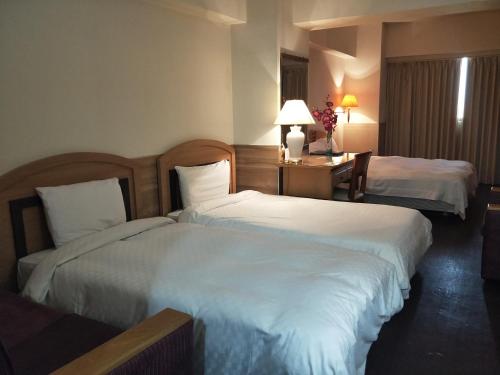 Katil atau katil-katil dalam bilik di Berkeley Business Hotel Zhongzheng
