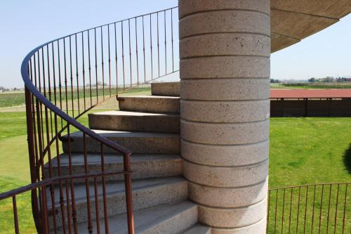 a set of stairs with a metal railing at Agriturismo La Lupa in Madonna della Provvidenza
