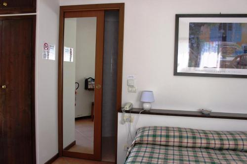 a bedroom with a bed and a picture on the wall at Agriturismo La Lupa in Madonna della Provvidenza