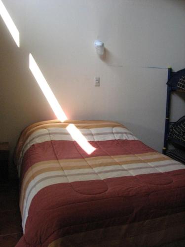 a bedroom with a bed with lights on it at Refugios Olmue Santa Teresa in El Maqui