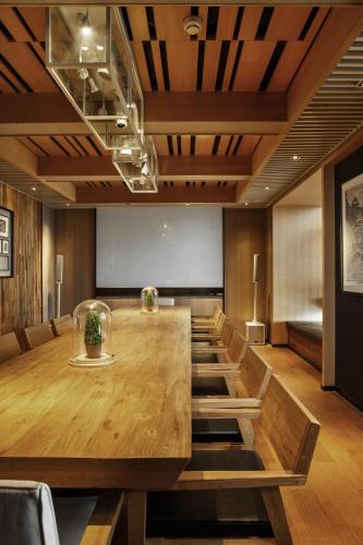 a conference room with a large wooden table and chairs at Bloom Boutique Hotel in Chongqing