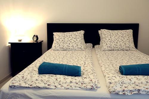 a bed with two pillows on top of it at Townhouse on Budapest border in Budaörs