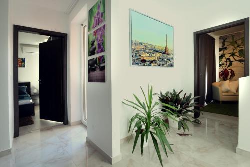 a living room with a potted plant on the floor at Townhouse on Budapest border in Budaörs