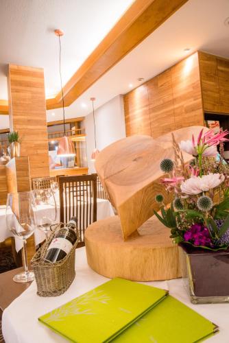a table with a vase of flowers on top of it at Best Western Plus Parkhotel Erding in Erding