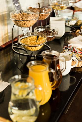 a table topped with glasses of food and drinks at STEELHOUSE Hotel in Třinec