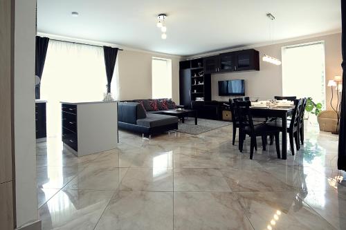 a living room with a table and a dining room at Townhouse on Budapest border in Budaörs
