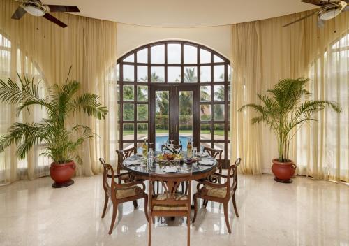 a dining room with a table and chairs at The LaLiT Golf & Spa Resort Goa in Canacona