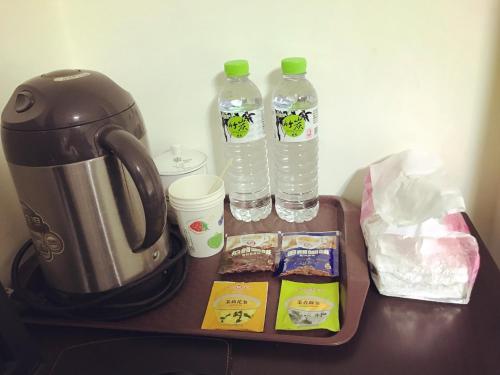 a table with a tea kettle and two bottles of water at Dongyin First Homestay in Dongyin