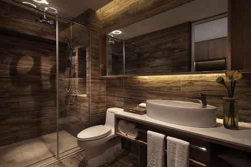 a bathroom with a sink and a toilet and a shower at Bloom Boutique Hotel in Chongqing