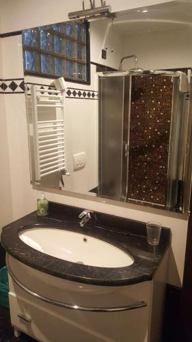 a bathroom with a sink and a mirror at B&b Il pesce doro in Camogli